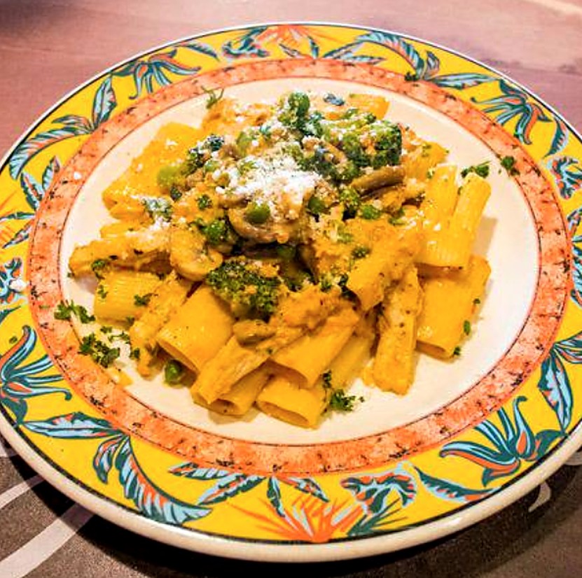 Rigatoni with broccoli, peas, and mushroom in a creamy sauce